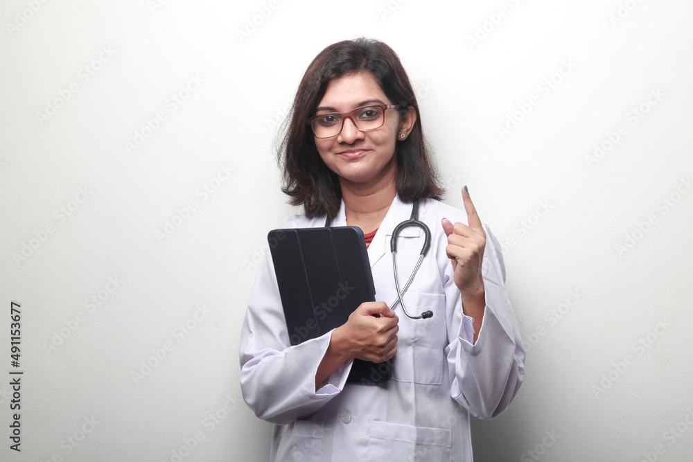 Portrait of a young female doctor of Indian origin with a pointed finger Portrait of a young female doctor of Indian origin with a pointed finger