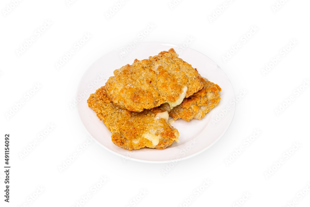 Fried chicken stuffed with cheese on a white plate isolated from white background Fried chicken stuffed with cheese on a white plate isolated from white background