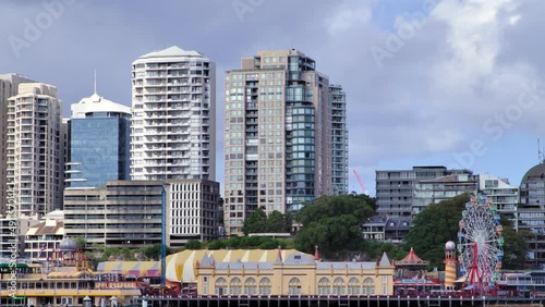 A closer telephoto view of high rise buildings near a city harbour waterfront. photo