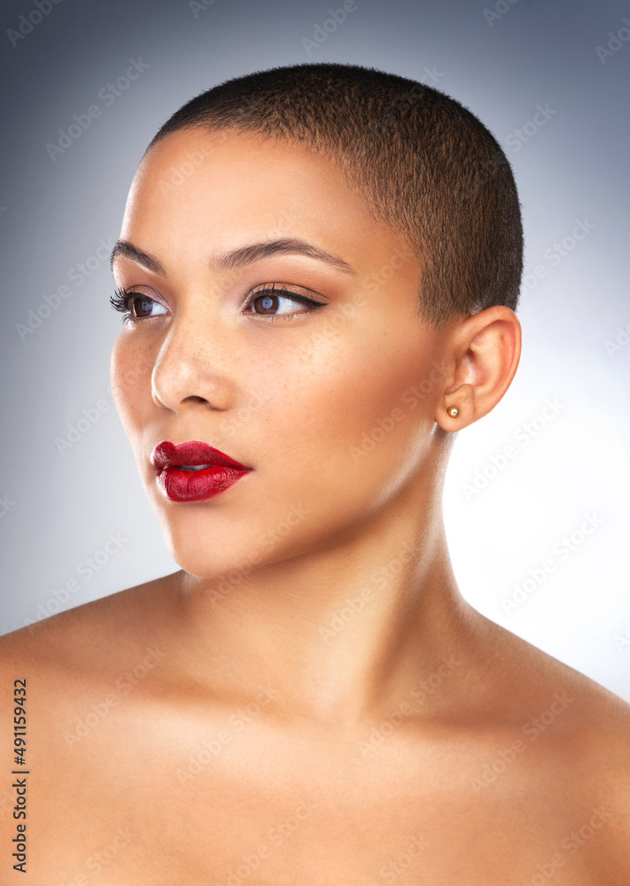 Theres something about red lipstick that makes me feel empowered. Studio shot of a beautiful young woman posing with a full face of make-up. Theres something about red lipstick that makes me feel empowered. Studio shot of a beautiful young woman posing with a full face of make-up.