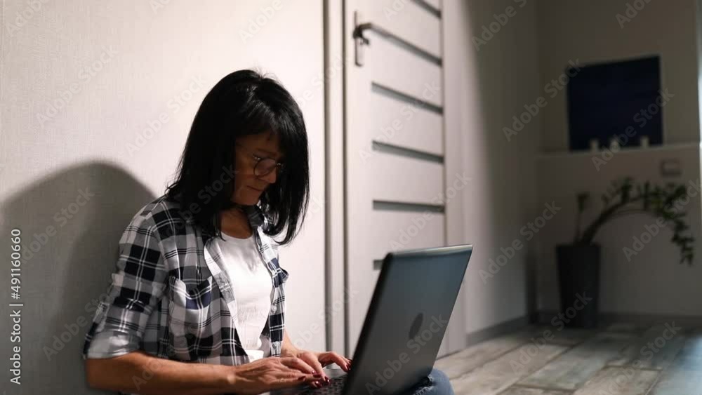 Mature Female typing on the computer for remote working Mature Female typing on the computer for remote working