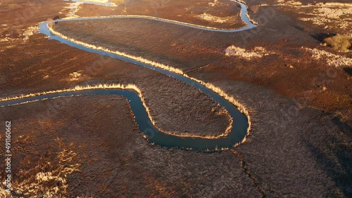 Burnt dry grass in the nature reserve of the river Seret, from a bird's eye view. Filmed in UHD 4k video.