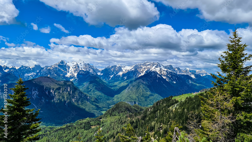 Panoramic view in spring from Frauenkogel on mountain peaks in the Karawanks and Julian Alps, Carinthia, Austria. Border with Slovenia. Triglav National Park. Jesenice in the Upper Drava valley. Hike