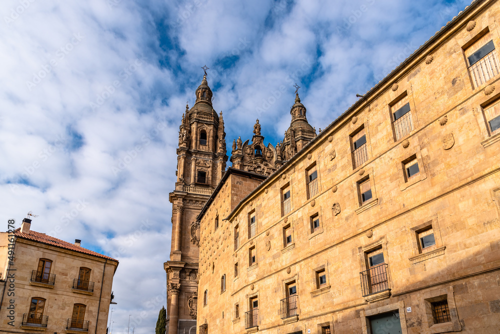 Casa de Las Conchas or House of the Shells in Plateresque style and the tower of the Church of La Clerecia . It is located in the old city of Salamanca
