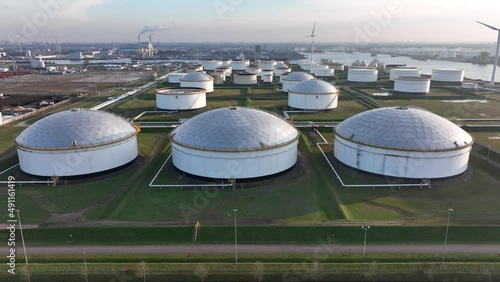 Commercial petrochemical oil gas fuel storage crude energy silos terminal at large industrial port. Huge storage of liquid aerial drone view in the port of Amsterdam, The Netherlands. photo