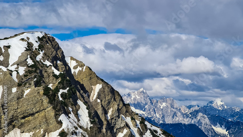 Panoramic view on Frauenkogel (Dovska Baba) with mountain peaks in the Karawanks, Carinthia, Austria. Borders Austria, Slovenia, Italy. Triglav National Park. Mount Triglav and Mangart in the back