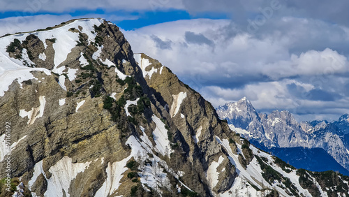 Panoramic view on Frauenkogel (Dovska Baba) with mountain peaks in the Karawanks, Carinthia, Austria. Borders Austria, Slovenia, Italy. Triglav National Park. Mount Triglav and Mangart in the back photo