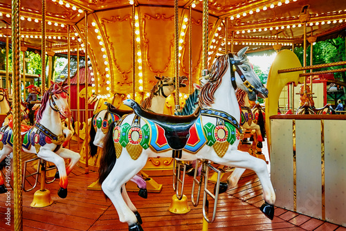 Carousel with colorful horses at amusement park, Merry go round with horse, Vintage ride attraction for children