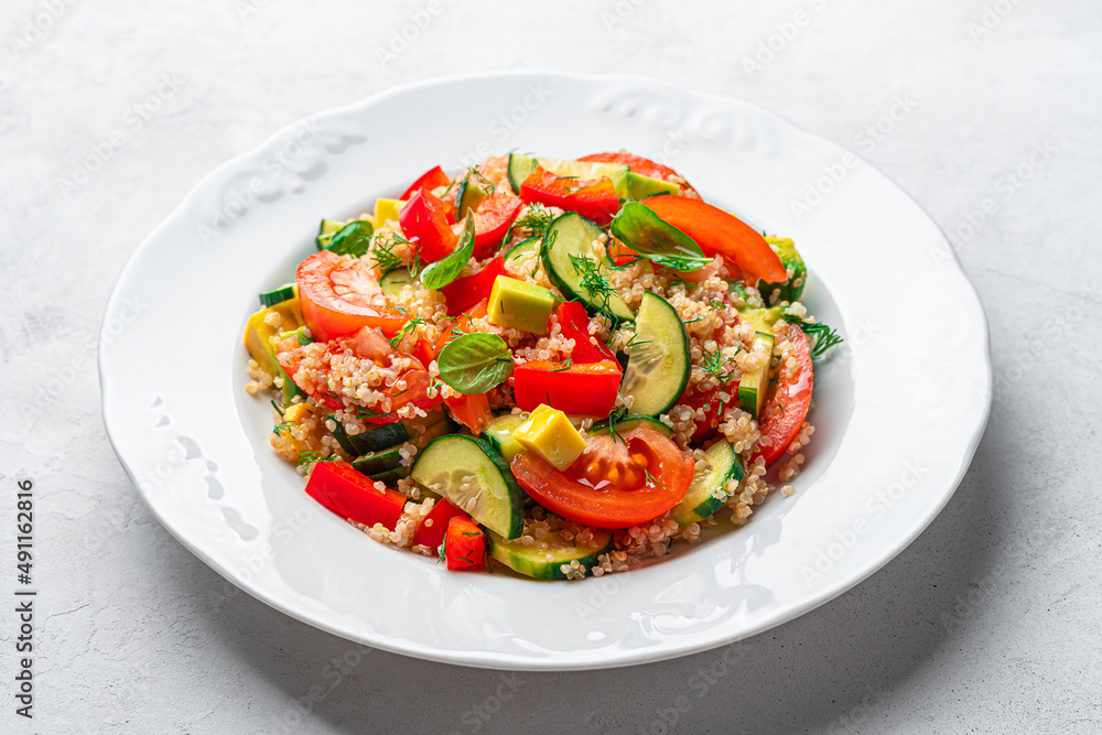 Healthy vegetable salad with quinoa and fresh herbs on a gray background. Healthy vegetable salad with quinoa and fresh herbs on a gray background.