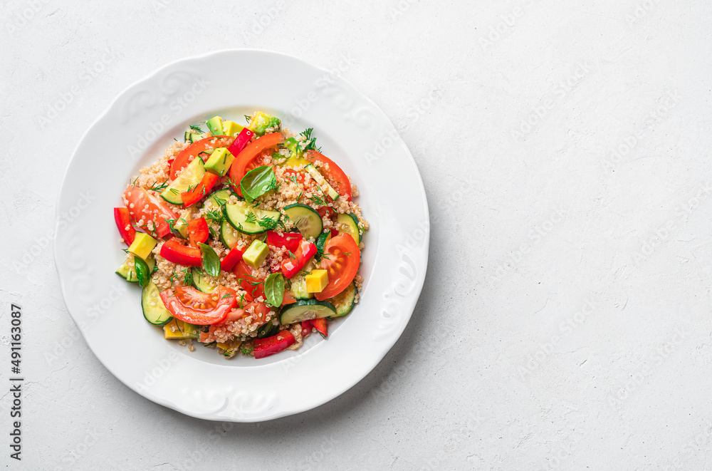 Vegetable salad with quinoa, dill basil on a gray background. Tabbouleh salad. Vegetable salad with quinoa, dill basil on a gray background. Tabbouleh salad.