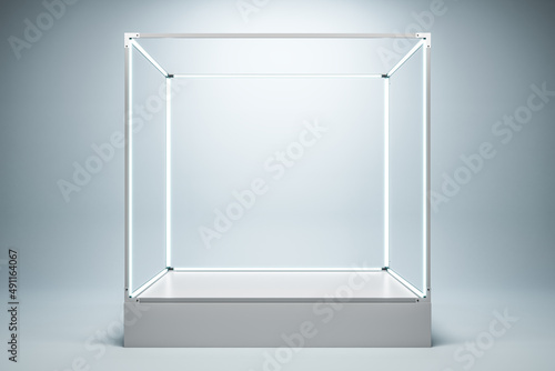 Obraz na plátne Empty illuminated glass showcase with mock up place on white wall background