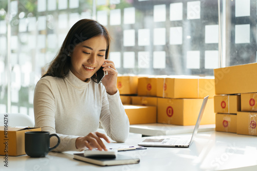 Wallpaper Mural Portrait young attractive asia female owner startup business look at camera work happy with box at home prepare parcel delivery in sme supply chain, procurement, omnichannel commerce online concept. Torontodigital.ca