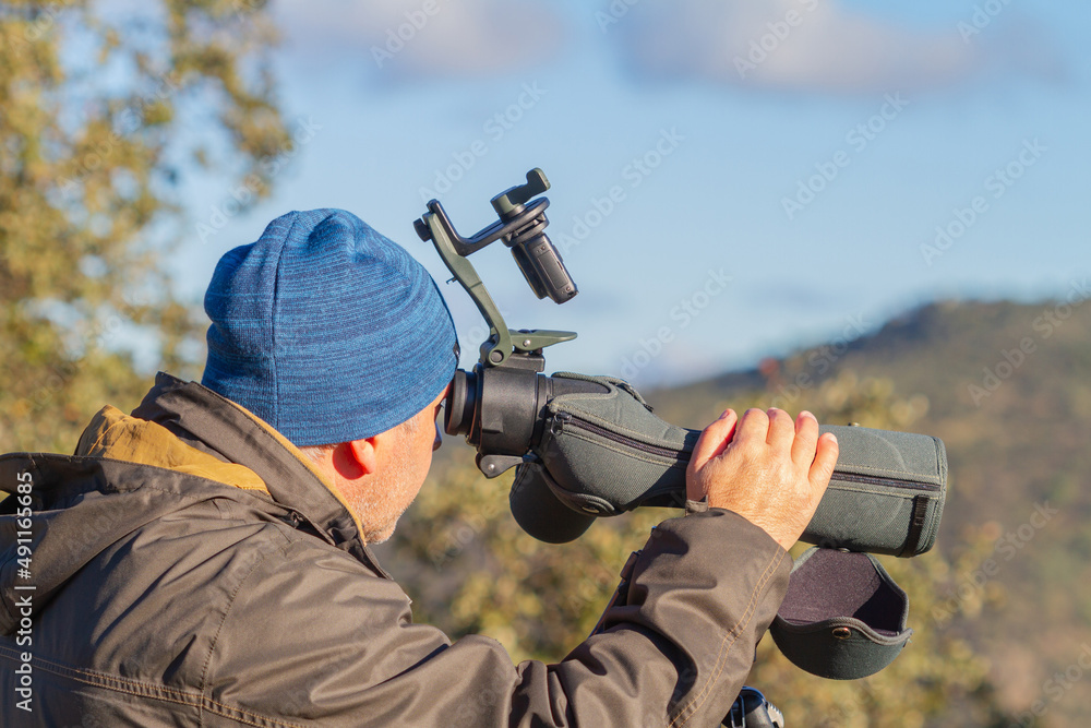 Man with telescope enjoying nature in the Sierra de Andújar, Jaén (Spain), nature concept.