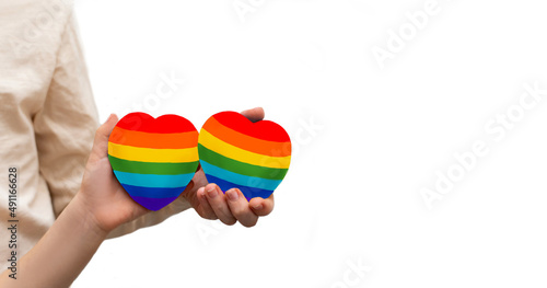 Closeup of rainbow painted hearts in hands of caucasian kids isolated on white background. Copy space. 