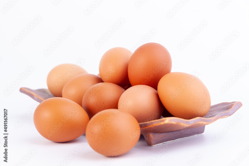 chicken eggs lies in a japaness ceramic saucer on white background. chicken eggs lies in a japaness ceramic saucer on white background.