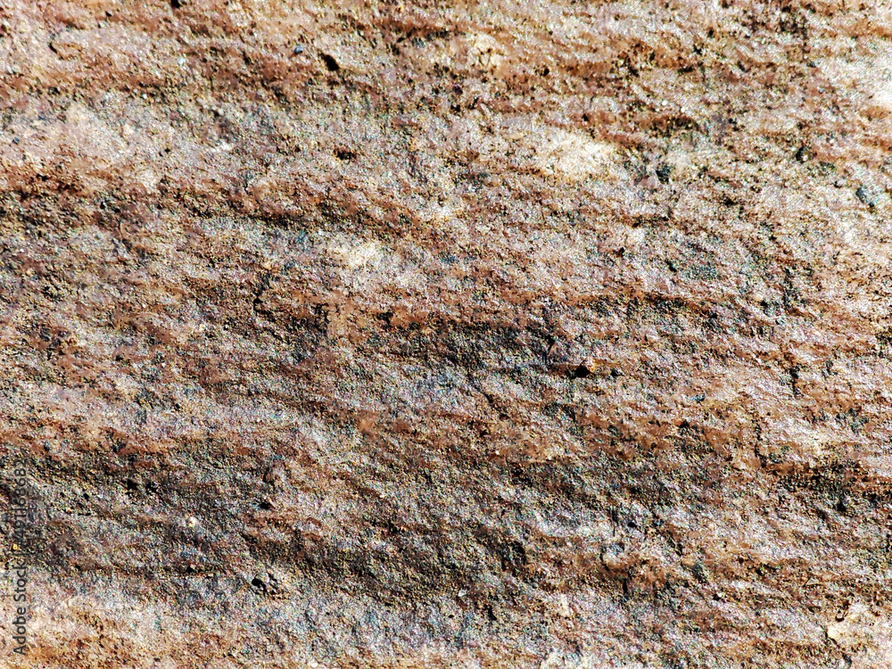 Red stone relief texture pattern close-up. Red stone relief texture pattern close-up.