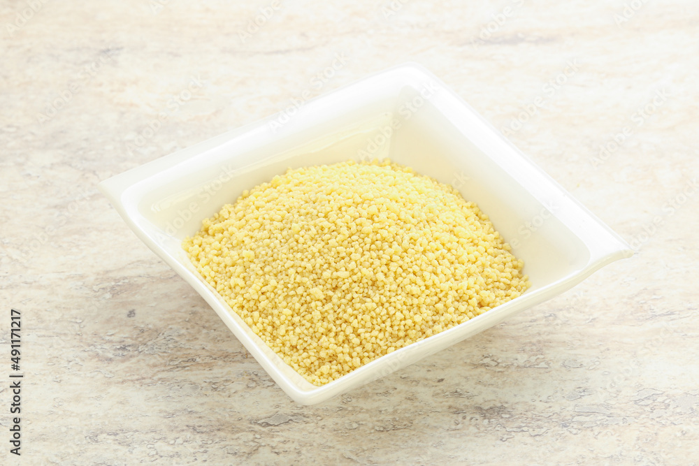 Raw couscous in the bowl Raw couscous in the bowl