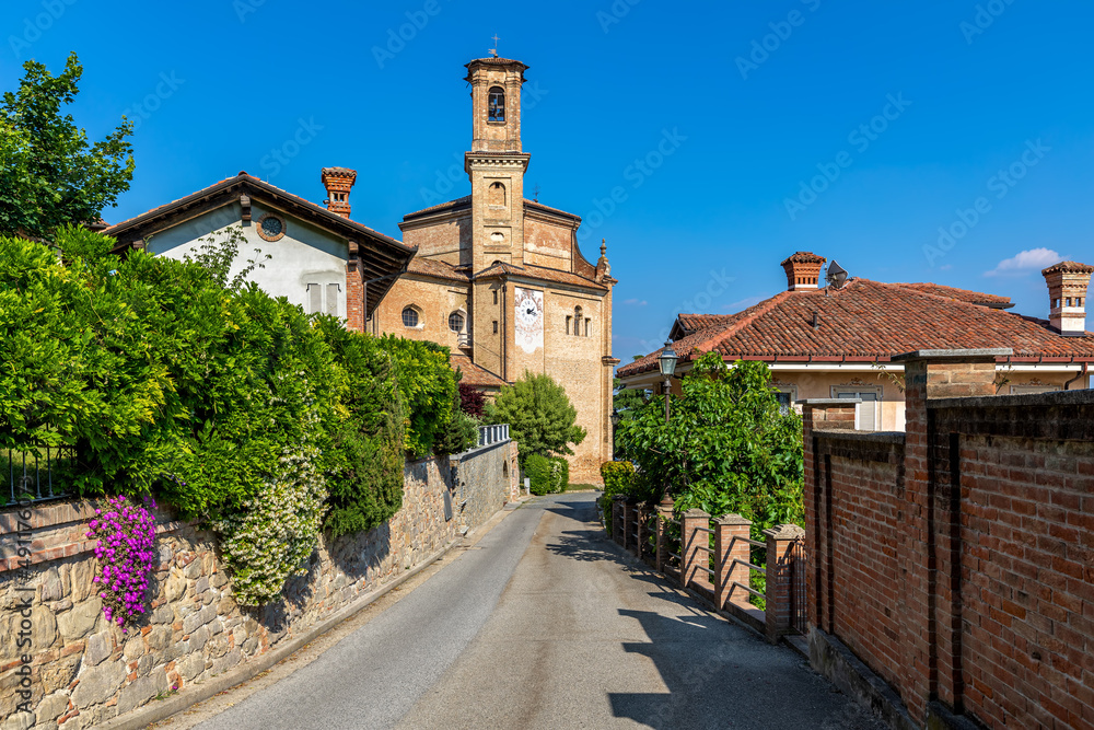 Narrow street and old church in Guarene, Italy.