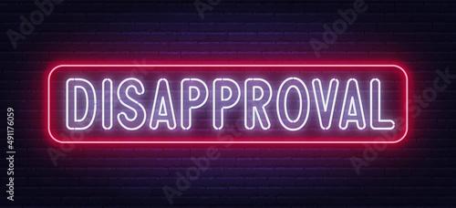 Neon sign Disapproval on brick wall background.
