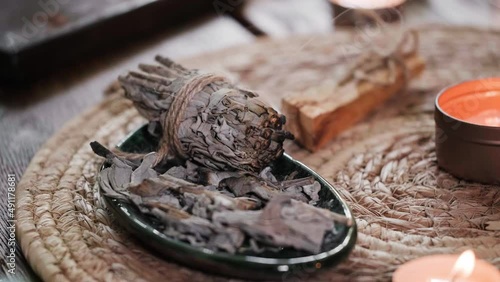 burning white sage, before ritual on the table with candles. Smoke of smudging treats pain and stress, clear negative energy and meditation. Nobody
