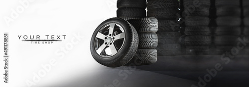 Tire shop, auto service and car wheel tyre store design. Pile of automobile black rubber tires advertising banner with tracks of wheel trade and discount price offer photo