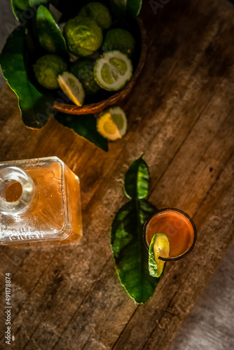 rum in a glass shot and bottle on dark wooden background, wealthy luxury bar atmosphere