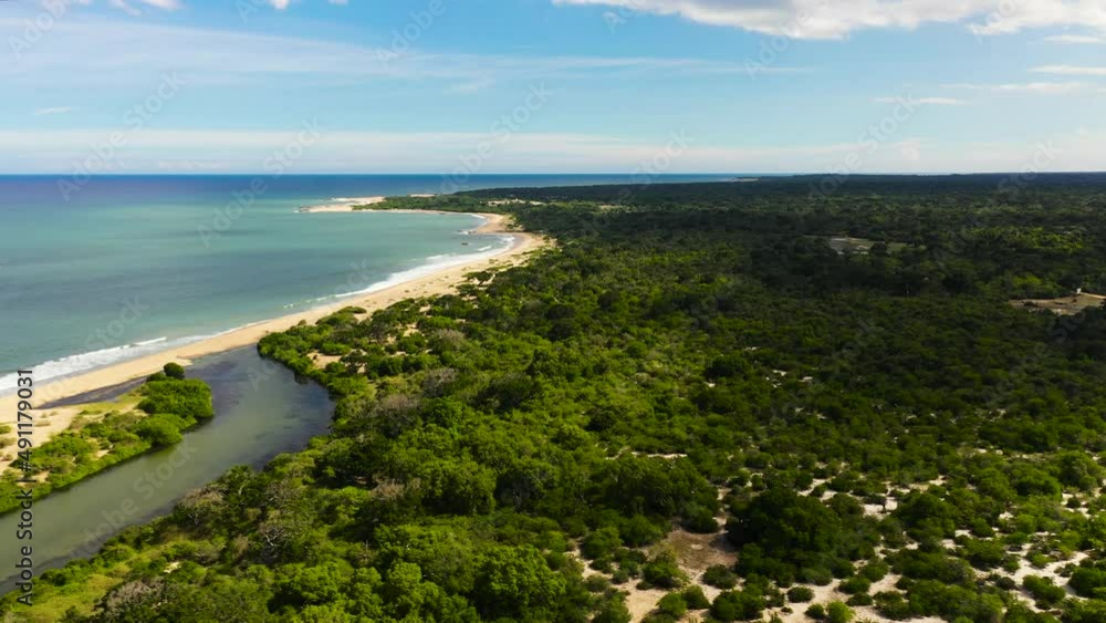 Aerial view of Ocean with a beach in the national park among the jungle. Aerial view of Ocean with a beach in the national park among the jungle.
