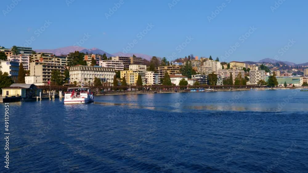 Passenger Ship in City of Lugano and Lake Lugano with Mountain in a Sunny Day in Lugano, Ticino, Switzerland. Passenger Ship in City of Lugano and Lake Lugano with Mountain in a Sunny Day in Lugano, Ticino, Switzerland.