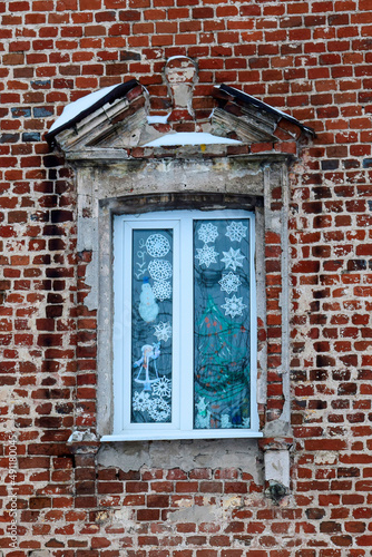 Window with New Year's decor in the old manor
