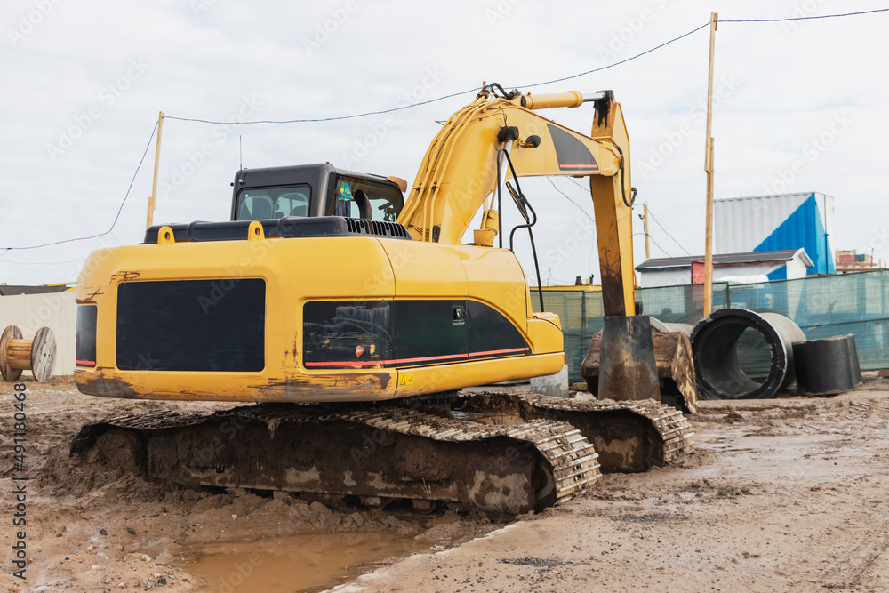 Heavy excavators at a construction site. Construction equipment for earthworks. Quarry excavator. Improvement of the territory and earthworks. Heavy excavators at a construction site. Construction equipment for earthworks. Quarry excavator. Improvement of the territory and earthworks.