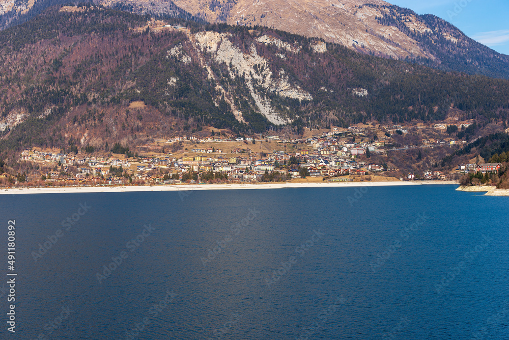Obraz premium Molveno village, tourist resort on the coast of the lake Molveno, Italian Alps, Brenta Dolomites, National Park of Adamello Brenta. Trentino Alto Adige, Trento, Italy, Europe.