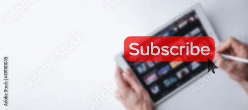 Subscribe button. Online video subscription red button. Internet service on laptop digital tablet blured banner background. Visual contents concept. Social networking service.