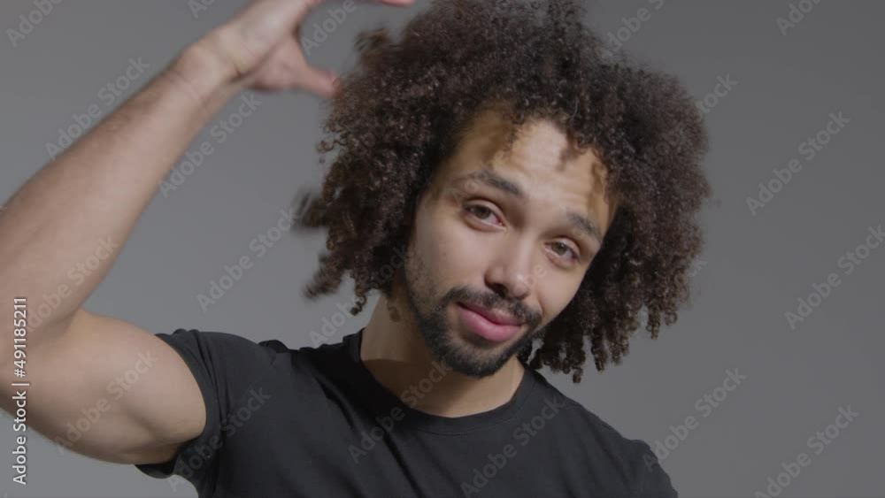 Mid Shot of Man Ruffling Hair and Smiling Mid Shot of Man Ruffling Hair and Smiling