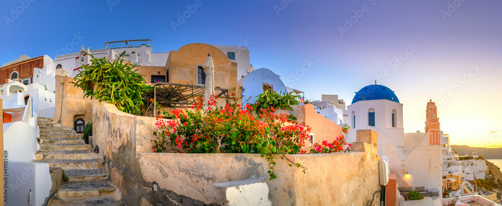 Panorama of the city of Oia on the island of Santorini, Greece. Picturesque houses and churches with blue domes over the caldera, Aegean Sea