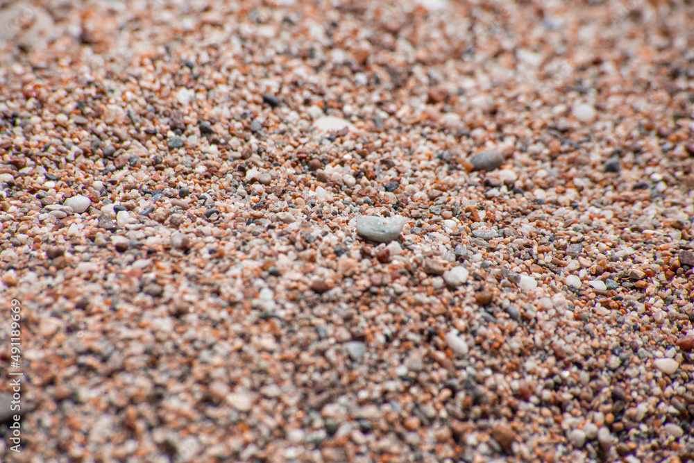 Small sea pebbles with stones with a reddish tint Small sea pebbles with stones with a reddish tint