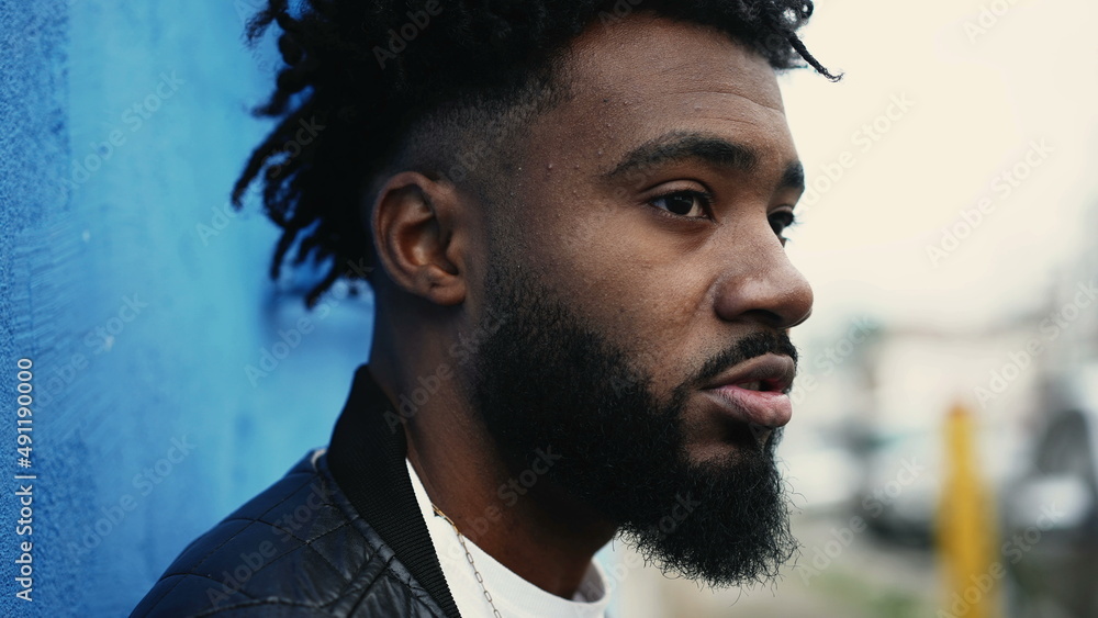 A pensive black man face closeup thinking A pensive black man face closeup thinking