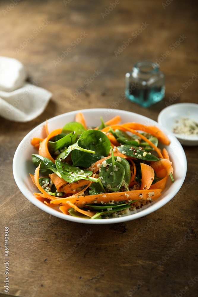 Healthy homemade spinach salad with carrot and sprouts Healthy homemade spinach salad with carrot and sprouts