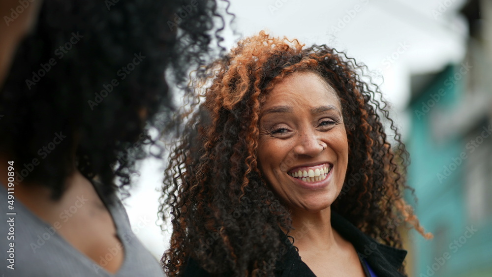 A happy black woman laughing and smiling a casual hispanic 40s lady real life laugh and smile A happy black woman laughing and smiling a casual hispanic 40s lady real life laugh and smile