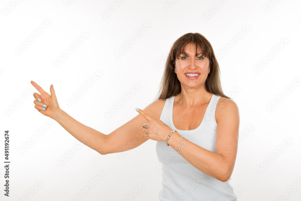 portrait senior woman pointing with both index fingers to one side isolated on white background portrait senior woman pointing with both index fingers to one side isolated on white background