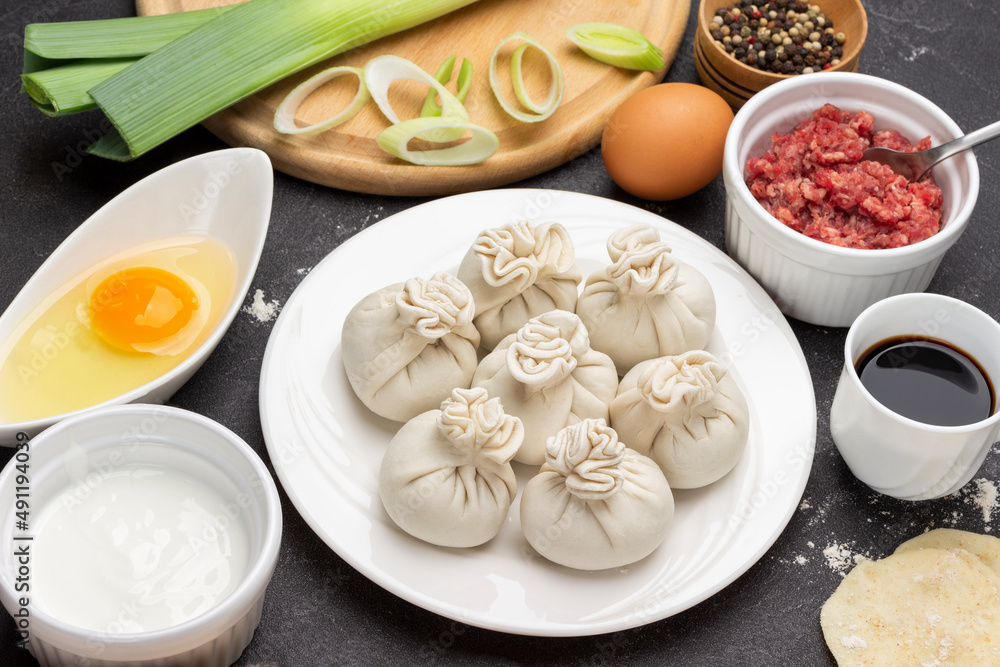 Raw dumplings on plate. Ingredients for making dumplings.