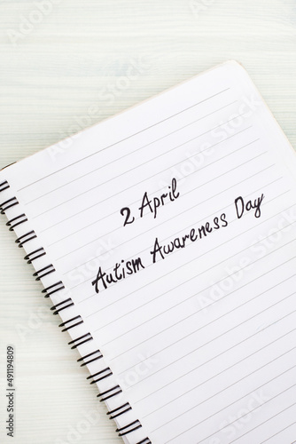 2April Autism Awareness Day written on notebook