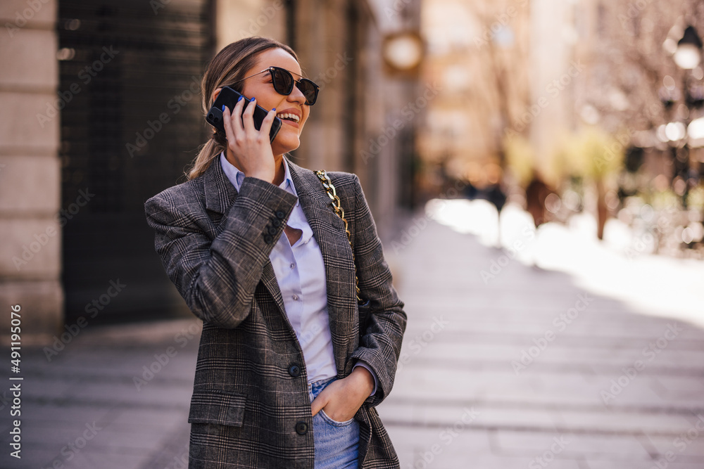 Fototapeta premium Happy girl, having a funny conversation over the phone.