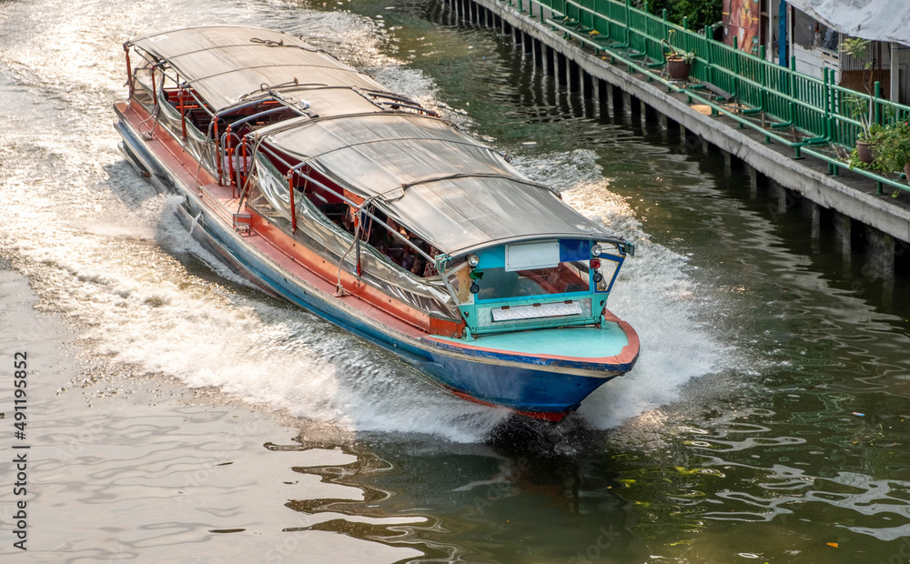 Water taxi on a canal in downtown Bangkok Thailand