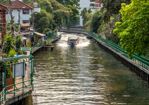Photography Water taxi in a canal in downtown Bangkok