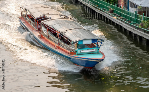 Photography Water taxi on a canal in downtown Bangkok Thailand