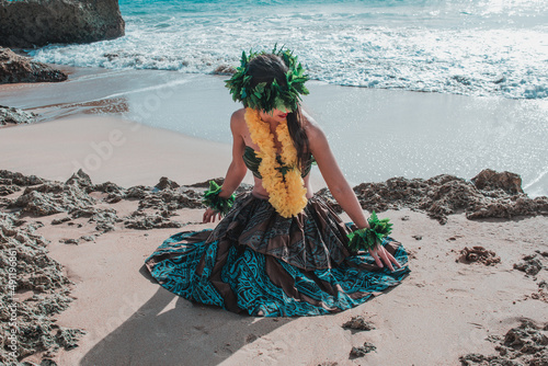 Fotografie, Obraz Unrecognizable woman on the beach smiling in Polynesian and Tahitian Hawaiian dancer attire