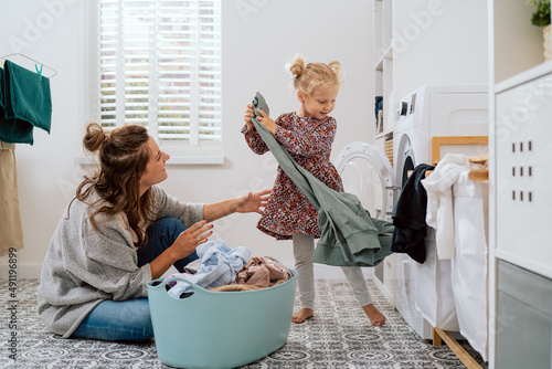 Murais de parede Mom spends time with daughter in bathroom, laundry room while doing daily chores