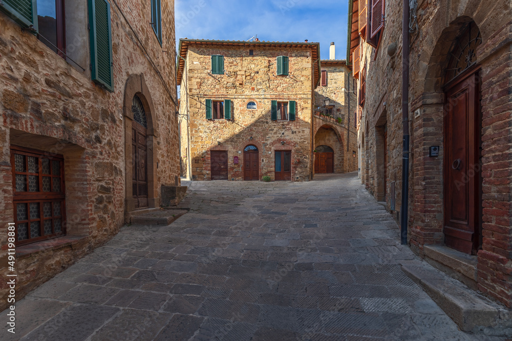 Large brick stone walls of the medieval buildings of Monticchiello city in Tuscany. Val d'Orcia, Italy