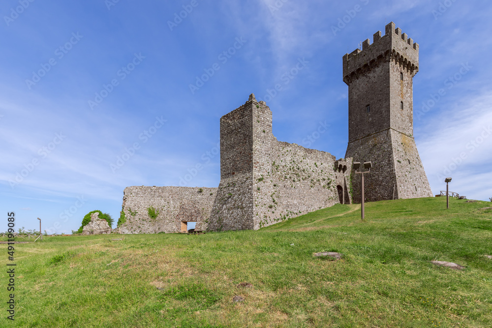 Daylight on Rocca of Radicofani fortress with plants on brick walls, Tuscany, Italy