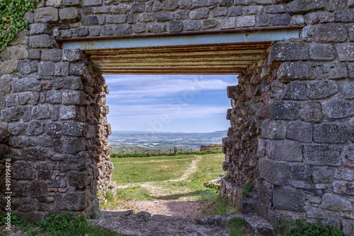 Entrance opening in an ancient thick brick wall of Radicofani fortress. Tuscany  Italy